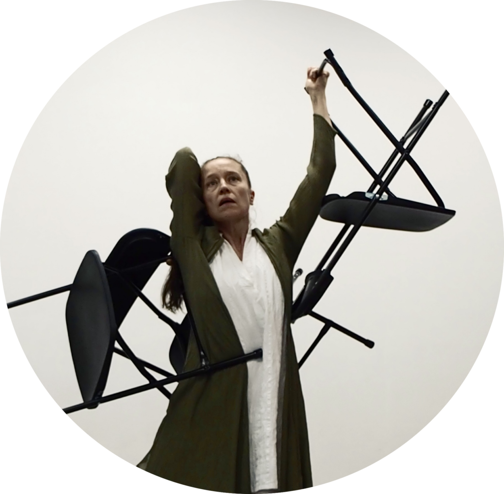 Jessica dances carrying chairs